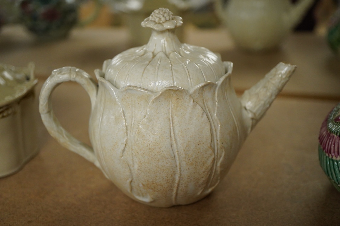 A rare Staffordshire saltglaze stoneware teapot, mid 18th century, an early 19th Wedgwood stoneware teapot and a stoneware butter tub and cover - 13cm wide (3)